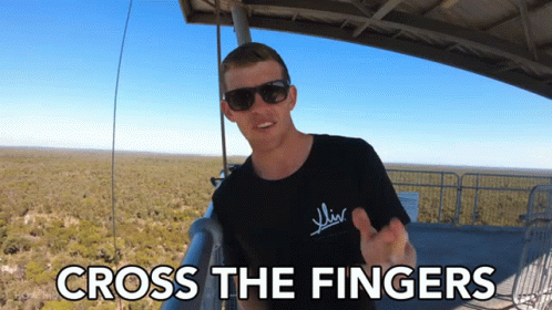 a person with sunglasses and a t - shirt that says cross the fingers
