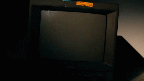 a small black television in a dimly lit room