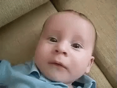 a young baby with a creepy expression on his face
