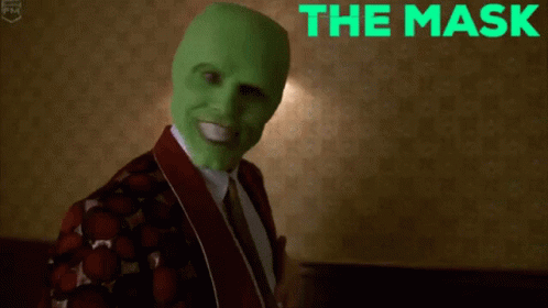 a person wearing green face paint and wearing a suit