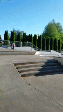a boy riding his skateboard down the side of stairs