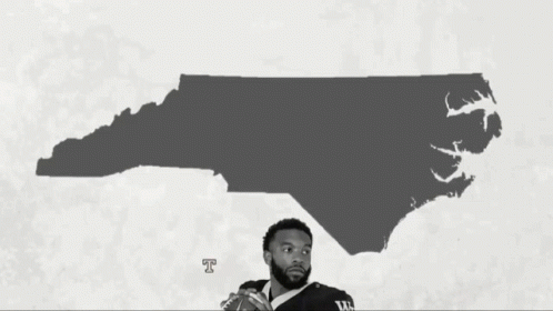 a basketball player is standing in front of a map of the state of mississippi