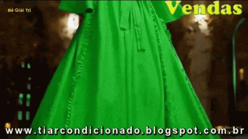 a woman dressed in a green gown is on display