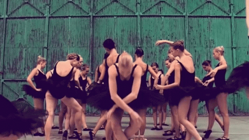 a dance performance with dancers holding hands and stretching