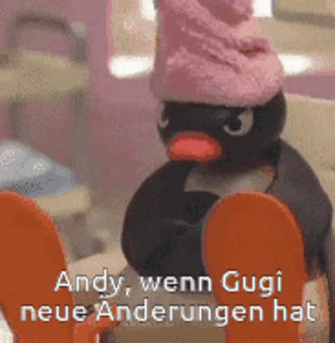 a toy penguin in a hat with text overlay