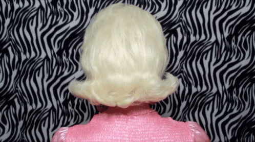 a white and blue wig is facing the wall