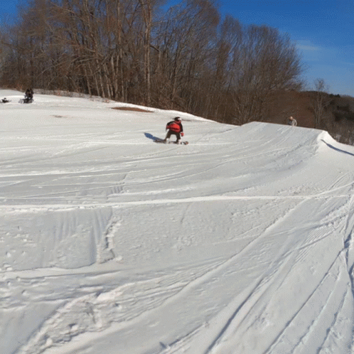 a person in the middle of snowboarding down a hill