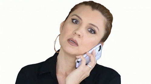 the woman in blue makeup uses her cell phone