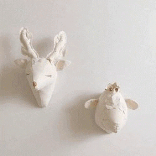 two white sheep made to look like birds
