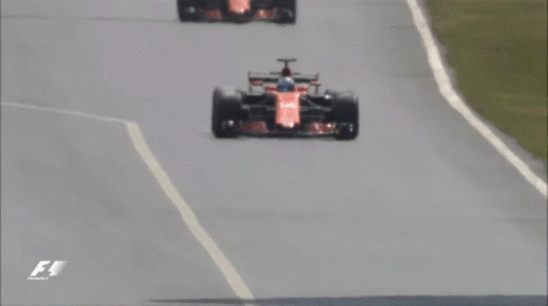 three racers on an asphalt track with one hing forward