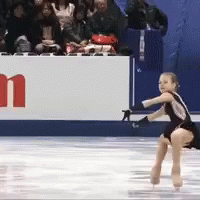 a figure is doing the splits on the skating rink