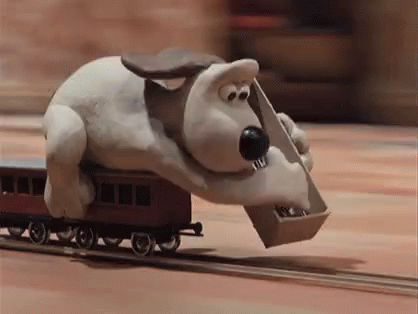 a animated character riding on a toy train