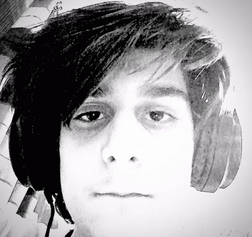 a man with headphones looking forward in black and white