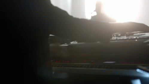 a blurry image of a person playing on the piano