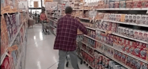 an elderly man is hing his shopping cart in the aisle