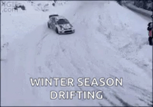 a car driving down the road in the snow