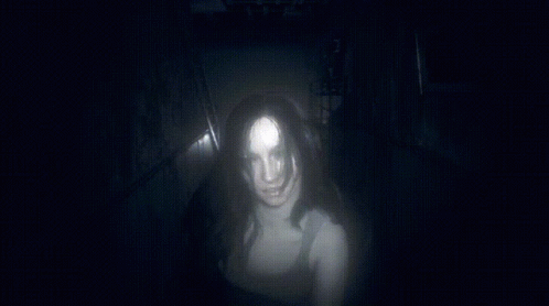 a person walking down a dark tunnel in a dark room