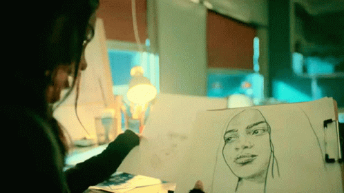 a person is looking at a drawing of a woman's face