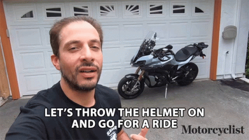 a man in brown shirt next to motorbike