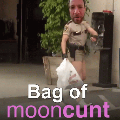 a police officer is standing next to a bag of mooncat litter