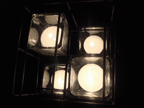 a group of lit candles on a table