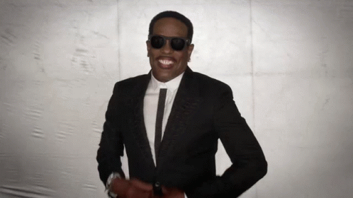 a person wearing a dark suit and shades