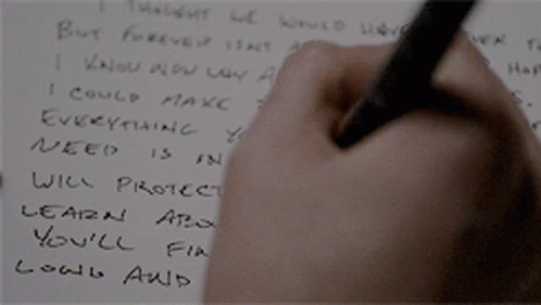 a hand with pen writing a note on it