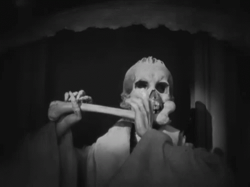 the skeleton is biting on a toothbrush in this black and white po