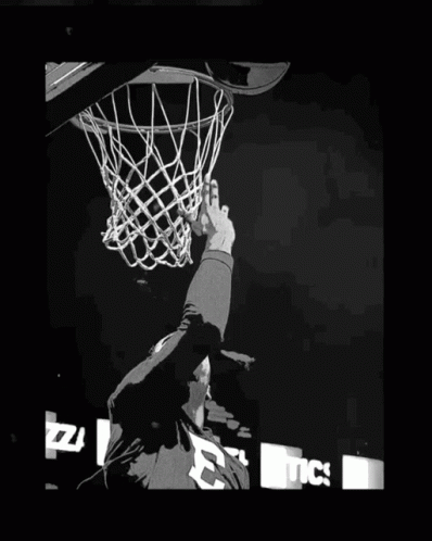 a person jumping into the air with a basketball