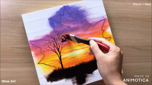 a person is drawing a landscape in a piece of paper