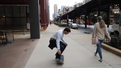 a young person skating on a street sidewalk