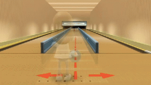 a bowling alley with lanes in the blue floor and an arrow