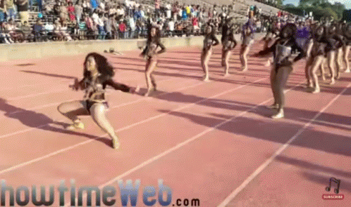 a girl jumps in the air while dancing at a track