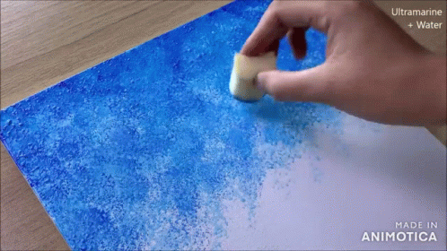 someone is making an orange piece of paper with orange dust