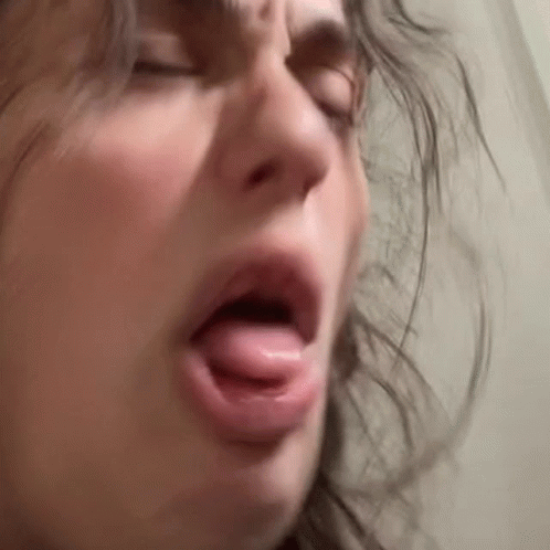 a woman has her mouth open in a creepy way