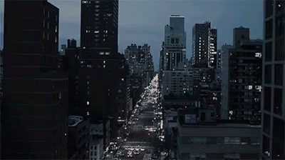 a large city street filled with traffic at night