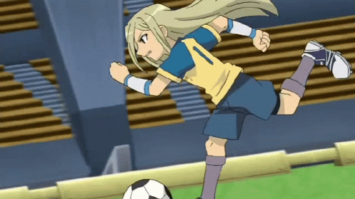 the woman is kicking a soccer ball in a stadium