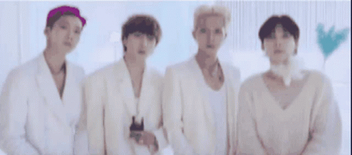 blurry image of four men in bathrobes and white shirts