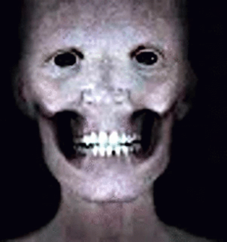 a creepy person's face with long teeth