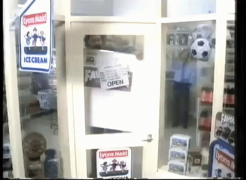 a very small fridge with some signs on the door
