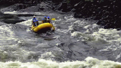 a group of people on a raft raft in a river