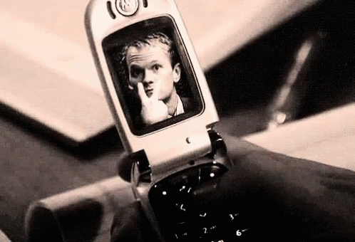 there is a cell phone with an image of a man on it