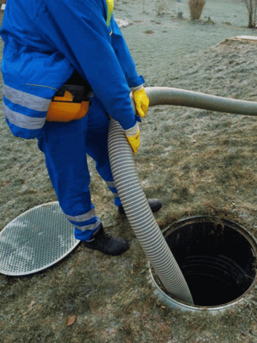 an attendant is using a portable pressure device to collect water