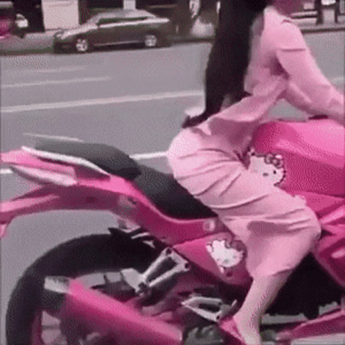 a person sitting on top of a motorcycle on a street