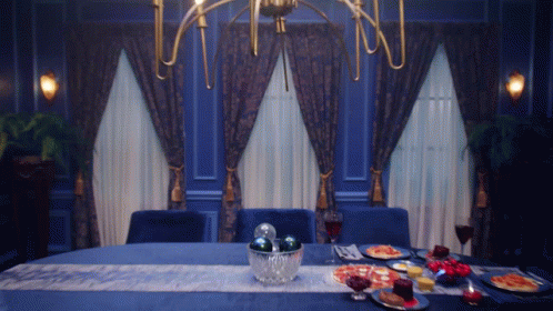 the centerpiece on the table has blue dishes and silverware