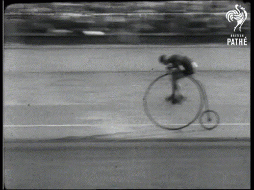 a man on a bicycle racing on a track