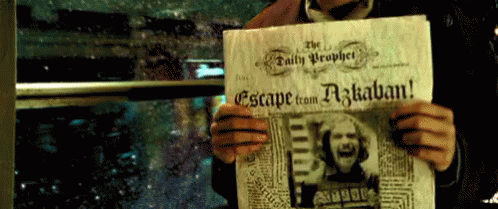a person holding a newspaper with a picture on it