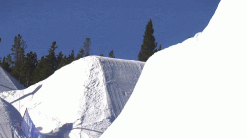 a snow boarder performing a trick while in the air
