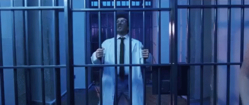 a man in a suit and tie inside a  cell