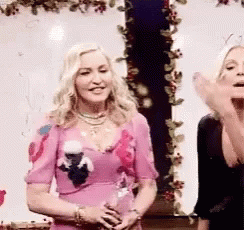 the two woman are singing on their own television set